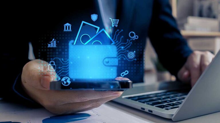 Person using a laptop at a kitchen table to review bank statements and categorize monthly household expenses.